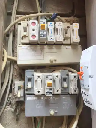 Before switchboard upgrade showing older ceramic fuse equipment and protective devices